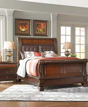 bedroom with elegant brown bedframe and dressers